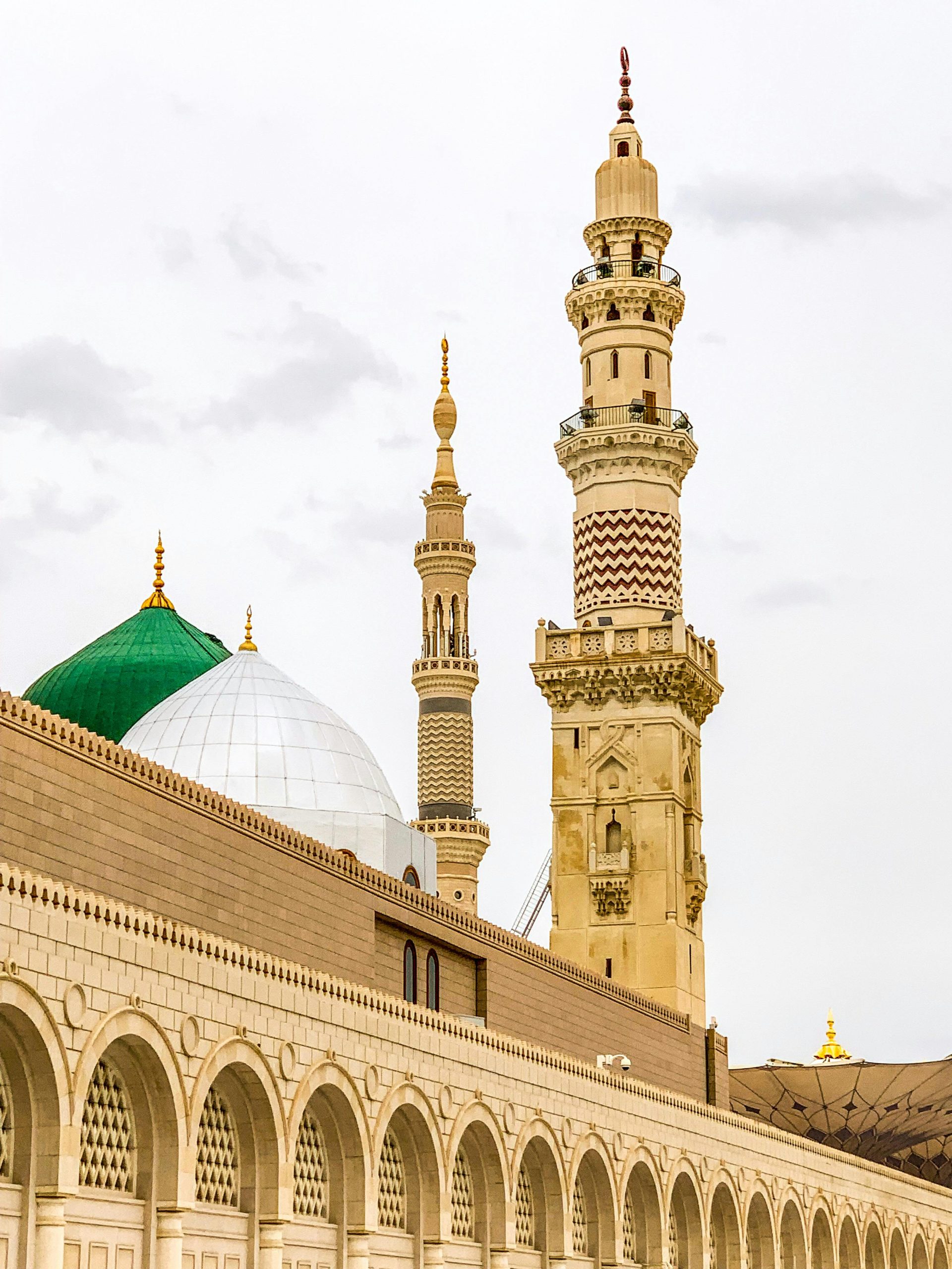 Iconic minarets of the Prophet's Mosque in Medina with detailed architecture and domes.